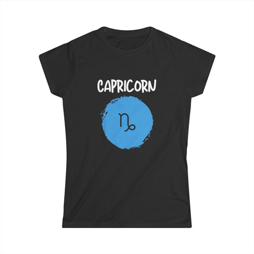 A black short-sleeve t-shirt with a graphic on the front featuring the word 'CAPRICORN' in white above a blue circular astrological symbol, shown on a plain white background.