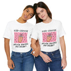 Two women wearing matching jeans and a matching white t-shirt that reads "Iced Coffee Never Broke My Heart" with a pink square that contains a drawing of hearts surrounding an iced coffee.