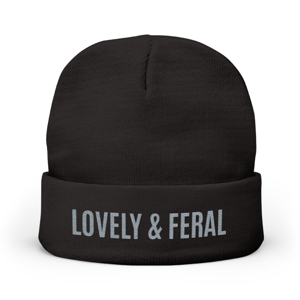 A black knit beanie hat with a folded cuff featuring the text 'LOVELY & FERAL' in light gray, shown on a plain white background.